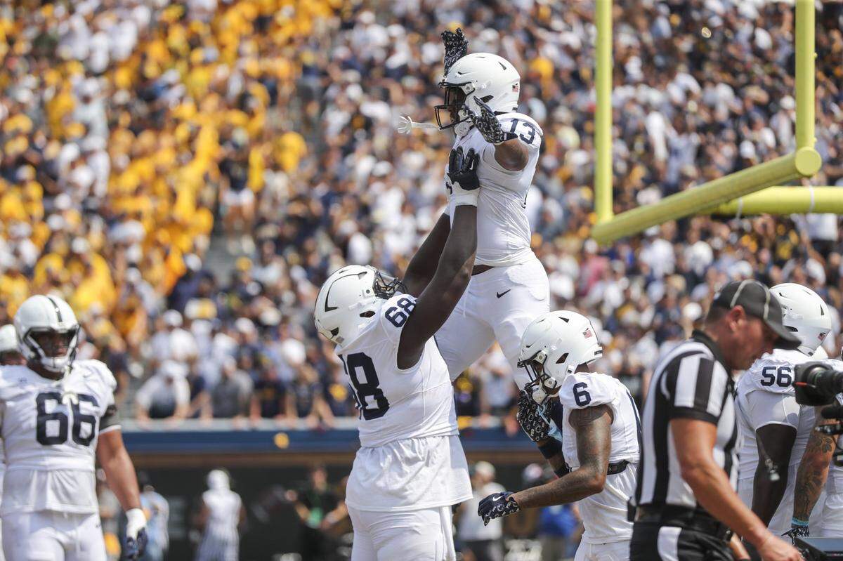 Aug 31, 2024; Morgantown, West Virginia, USA; Penn State Nittany Lions running back Kaytron Allen (13) celebrates with Penn State Nittany Lions offensive lineman Anthony Donkoh (68) after scoring a touchdown during the second quarter against the West Virginia Mountaineers at Mountaineer Field at Milan Puskar Stadium. Mandatory Credit: Ben Queen-USA TODAY Sports