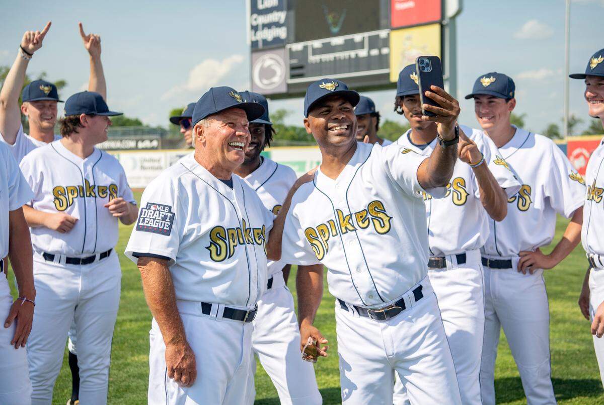 State College Spikes manager Dave Trembley laughs for a photo with hitting coach David Valdez and players after the team photo on Tuesday.