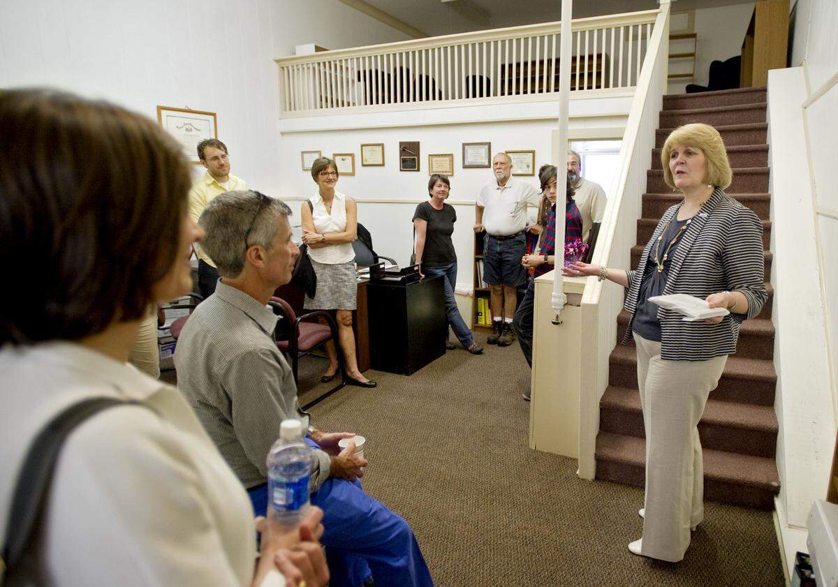 Anne Ard, executive director of the Centre County Women’s Resource Center, welcomes visitors to the new Bellefonte office during an open house and dedication on Friday, June 21, 2013.