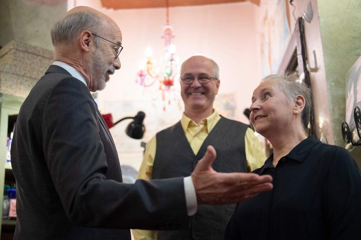 Pennsylvania Governor Tom Wolf speaks with Nittany Quill owner Joy Rodgers-Mernin during an event at her store on Wednesday, April 6, 2022 in State College, Pa. Governor Tom Wolf announced his plan to use American Rescue Plan funds to help local businesses.