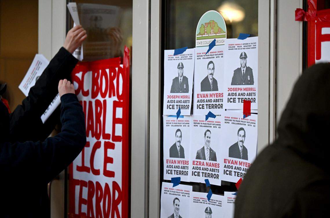 Protesters hang flyers and posters to the front doors of the State College Municipal building on Monday, April 20, 2026.  