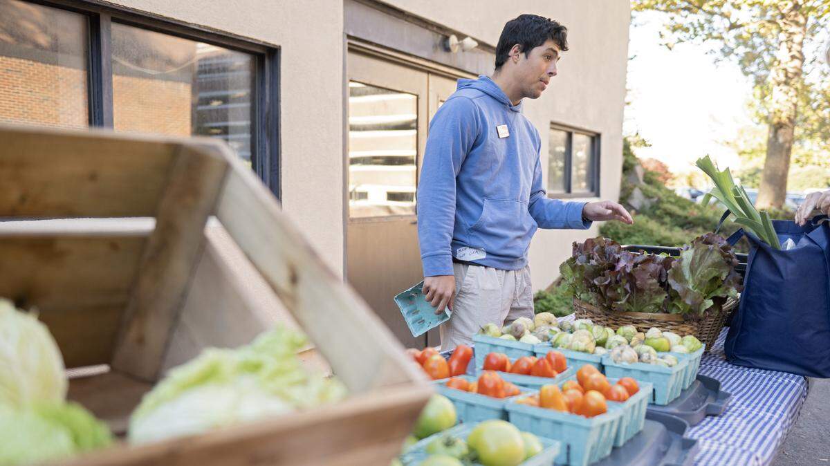 Sebastian Arauz chats about some of the vegetables available this week from the Student Farm at Penn State CSA on Thursday, Oct. 16, 2025.  