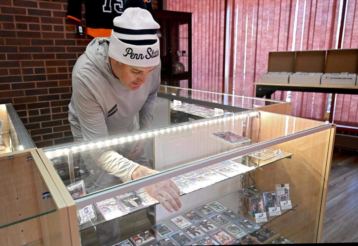 Jason Dambach talks Wednesday about some of the baseball cards at his new shop, Nittany Cards Plus. The sports card store is opening soon at 1631 S. Atherton St.