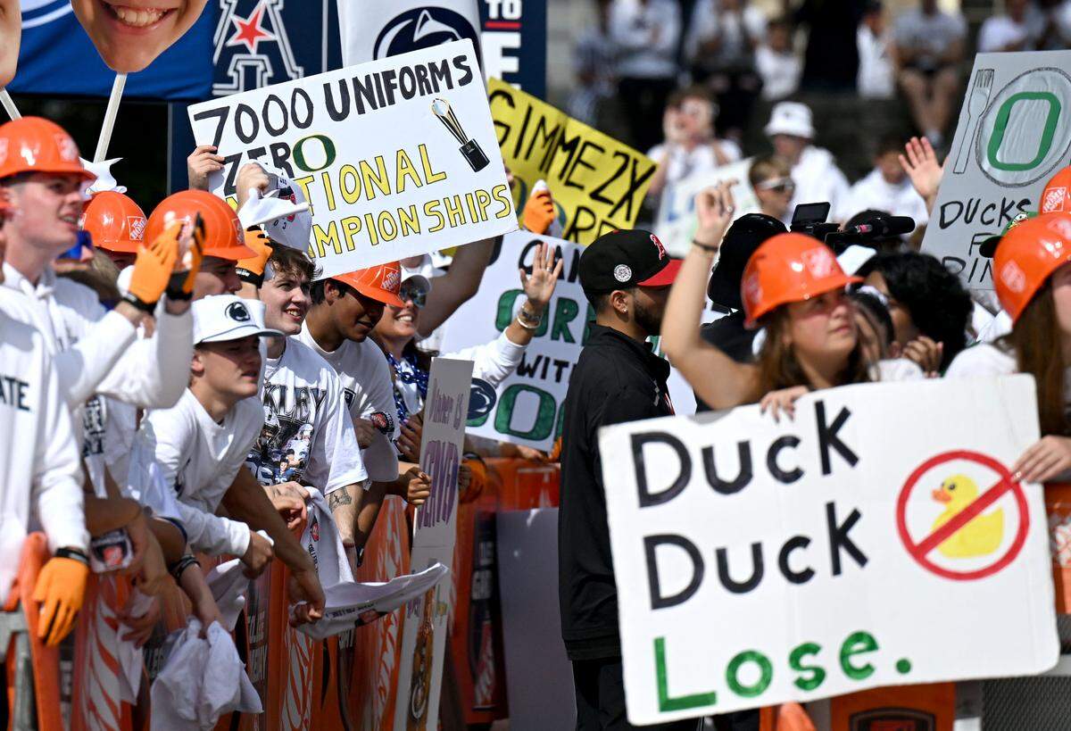 Fans hold up signs during ESPN’s College GameDay as it films at Penn State on Saturday, Sept. 27, 2025.  