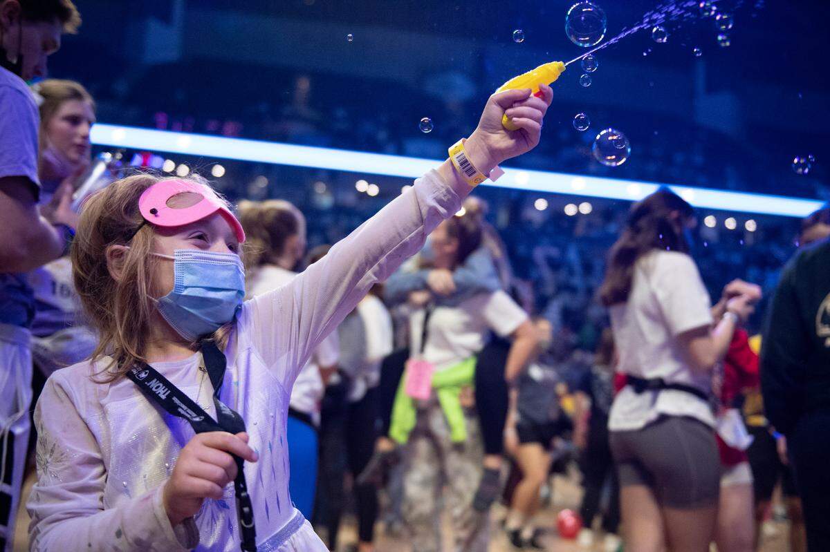 Kennedy Wilson, a Four Diamonds child, squirts a water gun during Thon on Saturday.