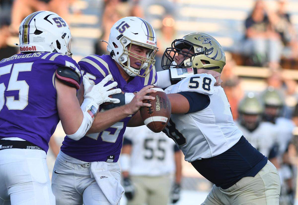 Bald Eagle Area’s Gage Gardner (58) pressures Bishop Guilfoyle quarterback Chase Kissell in the first quarter Saturday at Altoona’s Mansion Park.