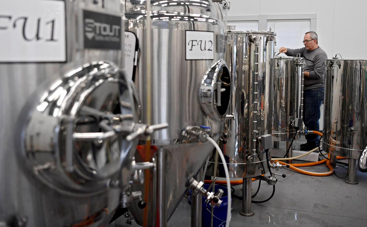 David Faussette prepares the tanks to make Jacked Up IPA at the Old Farmhouse Brewery on Tuesday.