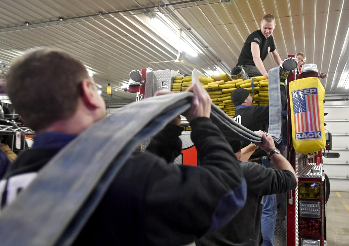Howard Fire Department volunteers load hoses onto the engine during a work night on Jan. 24.