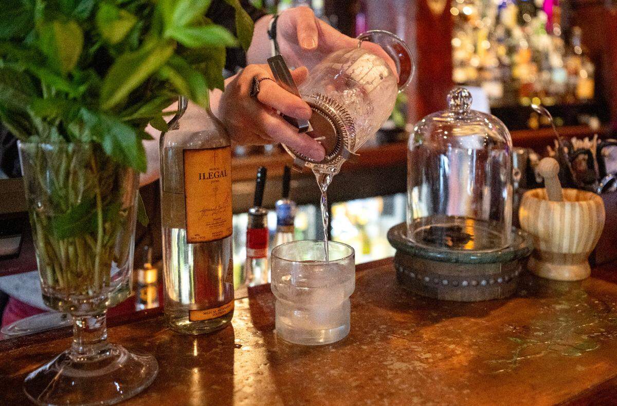 Sc’Eric Horner pours a White Lodge cocktail into a glass before adding the finishing touches at Pine Grove Hall on Thursday, May 23, 2024.