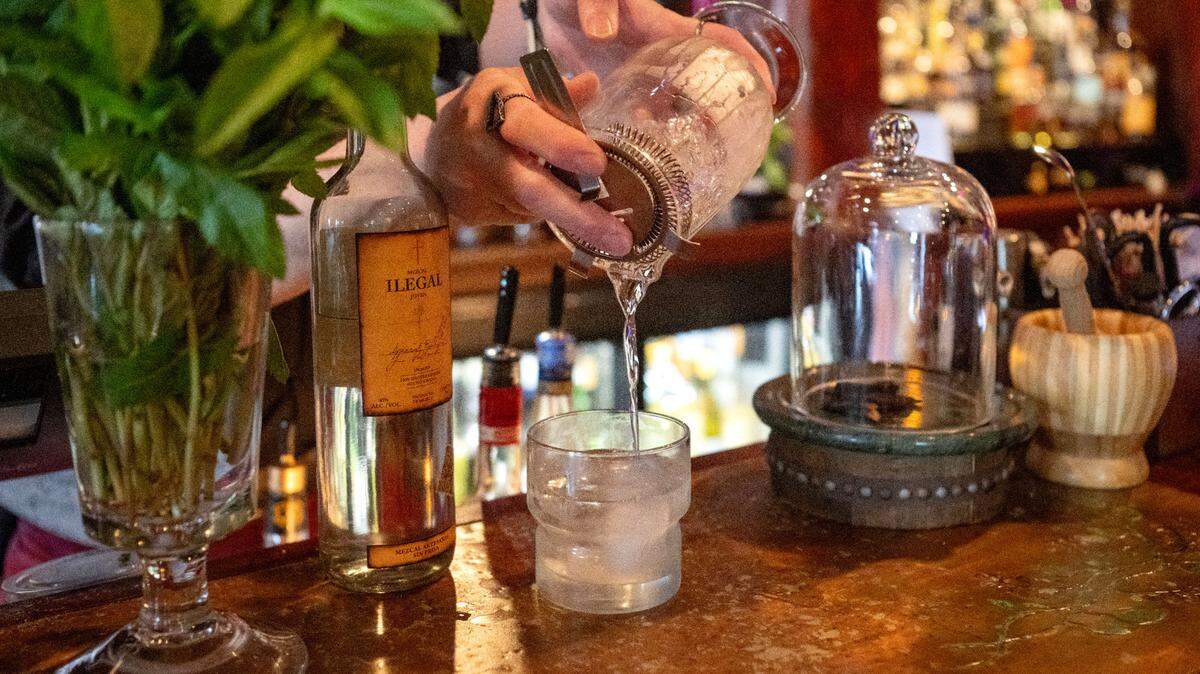 Sc’Eric Horner pours a White Lodge cocktail into a glass before adding the finishing touches at Pine Grove Hall on Thursday, May 23, 2024.  