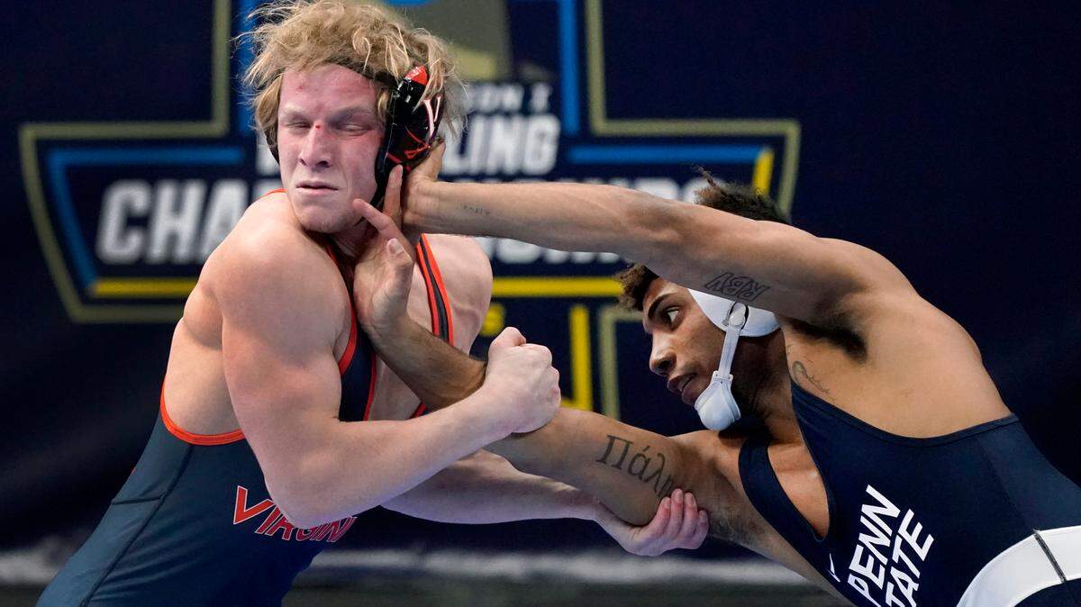 Virginia’s Louie Hayes, left, takes on Penn State’s Roman Bravo-Young during their 133-pound match in the quarterfinal round of the NCAA wrestling championships Friday, March 19, 2021, in St. Louis.