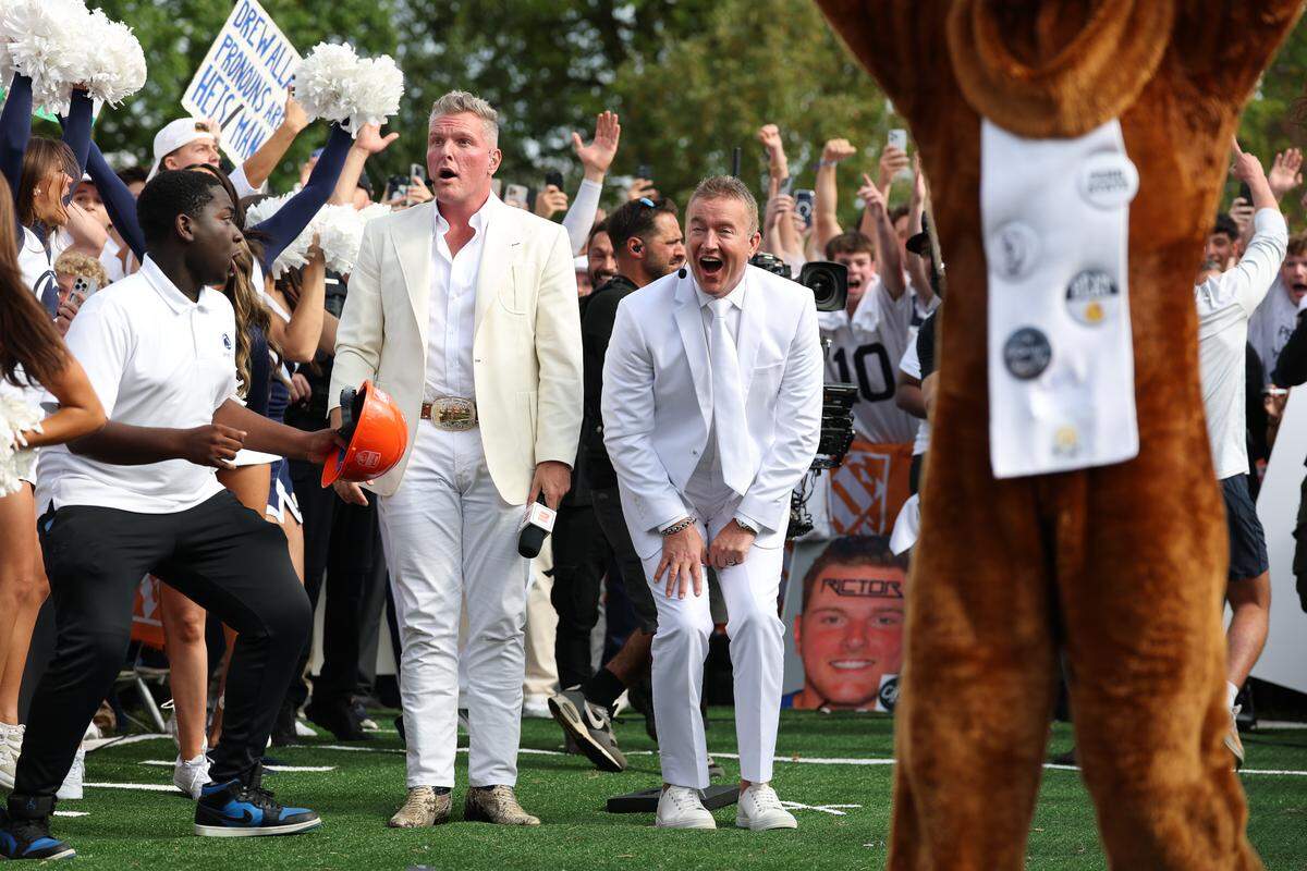 College GameDay analysts Kirk Herbstreit and Pat McAfee watch as Carson Albright’s 33-yard field goal is good to earn him and fellow student William $300,000 total, or $150,000 each, on Saturday morning during the Field Goal Kicking Challenge segment on the set of College GameDay at Penn State.