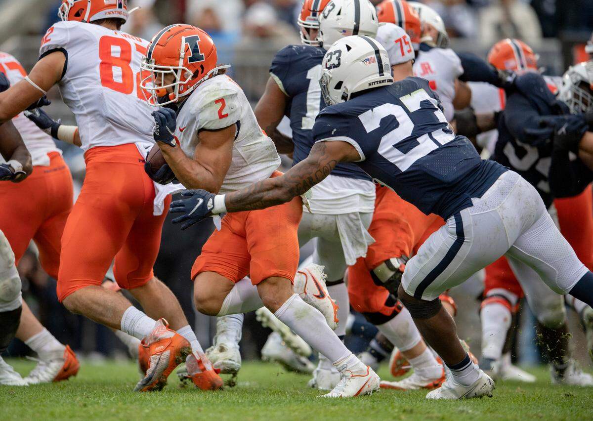 Penn State linebacker Curtis Jacobs reaches for Illinois running back Chase Brown during the game on Saturday, Oct. 23, 2021.