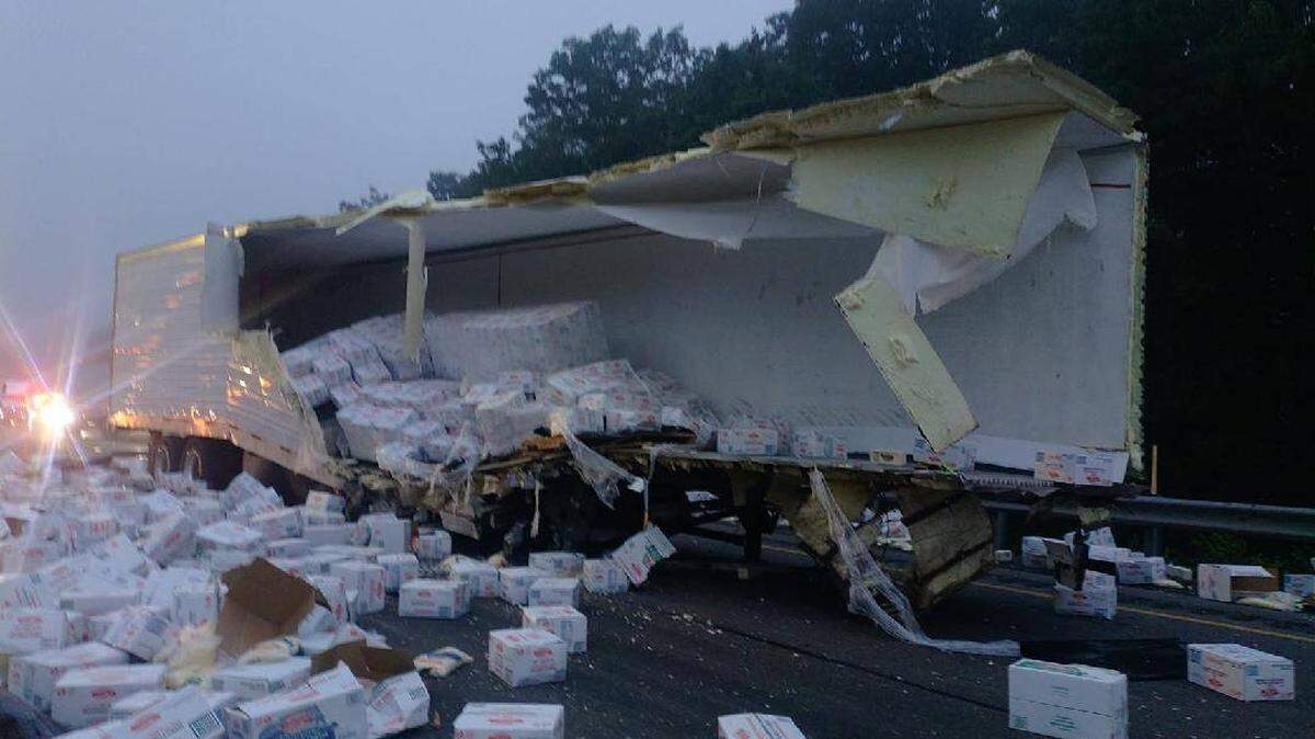 Boxes of mozzarella cheese sit on the road after falling out of a trailer following a collision on Wednesday morning.