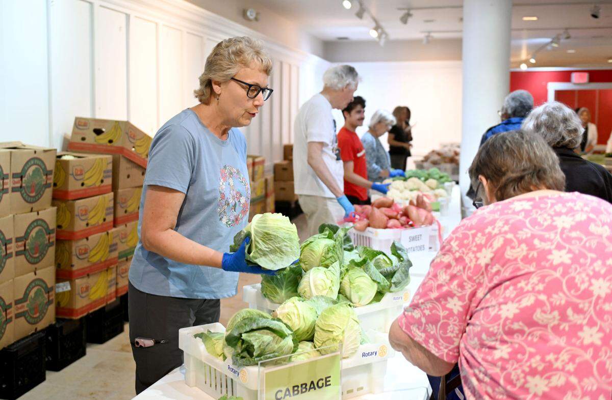 Volunteers hand out vegetables during the State College Food Bank No-Cost Produce Market on Tuesday, July 1, 2025 at the Nittany Mall.