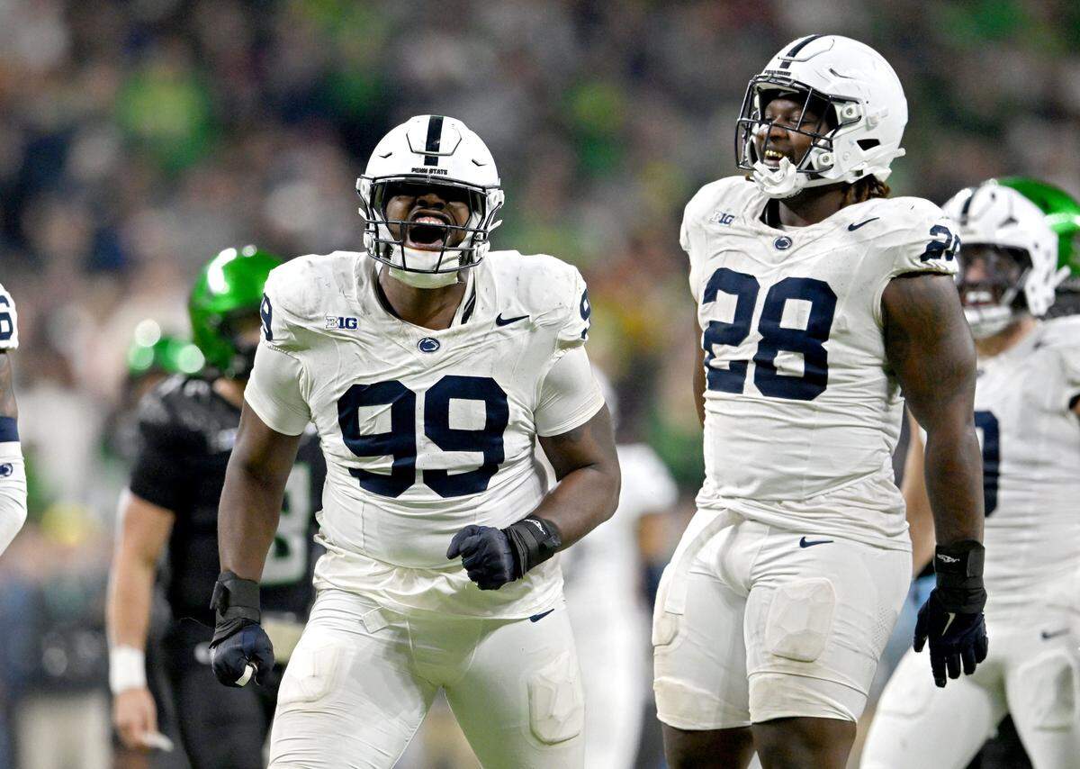 Penn State defensive tackles Coziah Izzard (99) and Zane Durant (28) celebrate after a play against Oregon in the first half of the Big Ten Championship game at Lucas Oil Stadium on Saturday, Dec. 7, 2024.