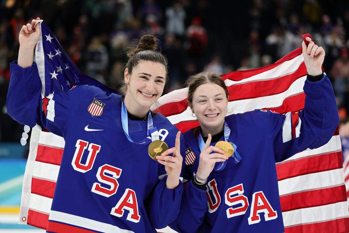 MILAN, ITALY - FEBRUARY 19: Gold medalists Megan Keller #5 and Tessa Janecke #22 of Team United States celebrate after the medal ceremony for Women's Ice Hockey following the Women's Gold Medal match between the United States and Canada on day thirteen of the Milano Cortina 2026 Winter Olympic games at Milano Santagiulia Ice Hockey Arena on February 19, 2026 in Milan, Italy. (Photo by Andreas Rentz/Getty Images)