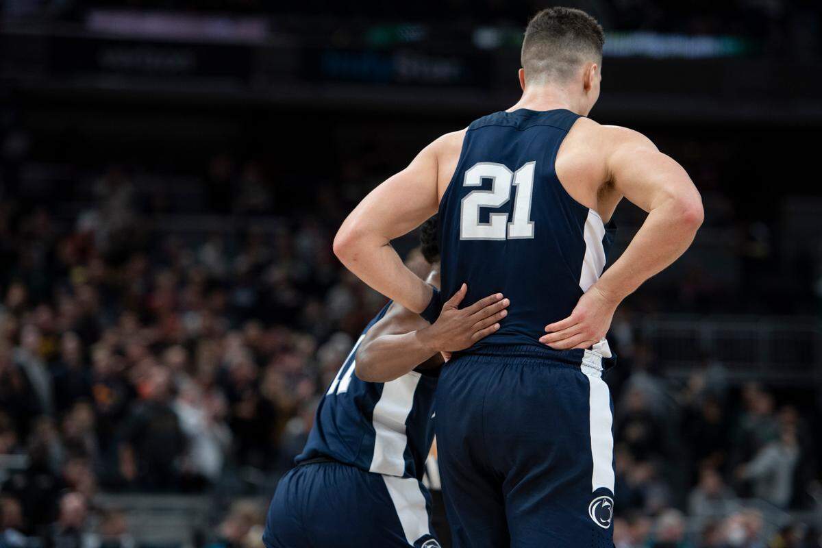 Penn State guard Jaheam Cornwall (11) puts his hand on the back of Penn State forward John Harrar (21) during a game against Purdue in the Big Ten men’s basketball tournament at Gainbridge Fieldhouse on Friday in Indianapolis.