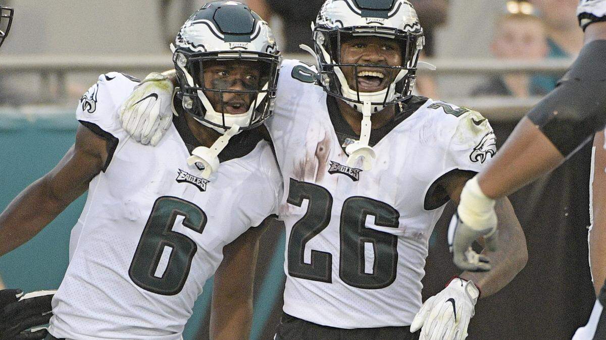 Philadelphia Eagles running back Miles Sanders (26) celebrates wide receiver Greg Ward’s (6) 38-yard touchdown against the Jacksonville Jaguars during the first half of Thursday's preseason game. 