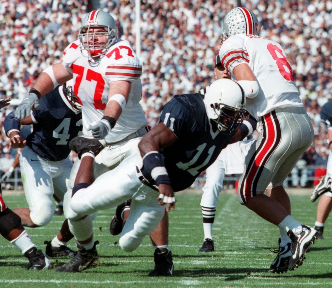 Penn State's LaVar Arrington (11) pressures   Ohio Statequarterback Steve  Bellisari (8) as Tyson Walter (77) tries to blockduring their game  Saturday, Oct. 16, 1999.