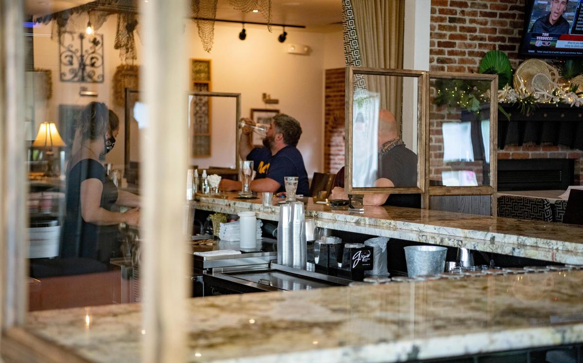 Partitions have been placed around the bar at Gigi’s Southern table to help separate patrons on Friday, May 29, 2020.