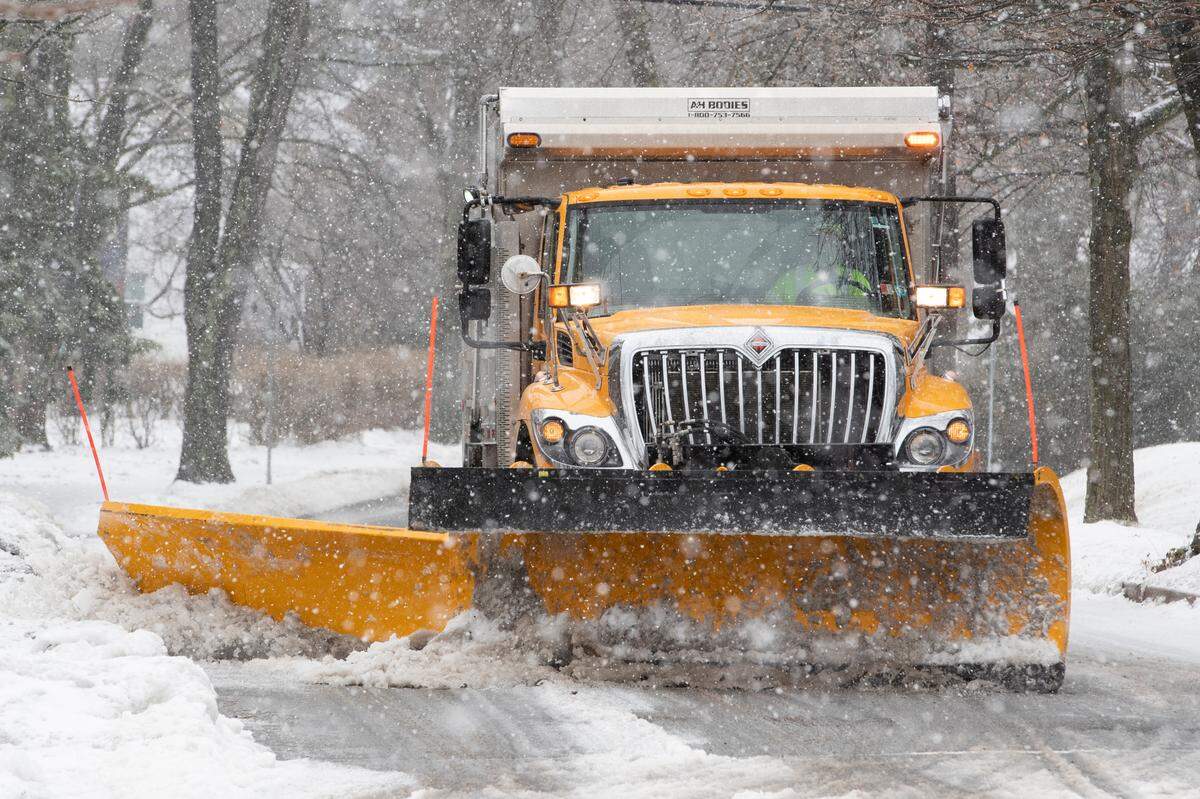 A borough snow plow clears West Hamilton Avenue after a storm Friday.