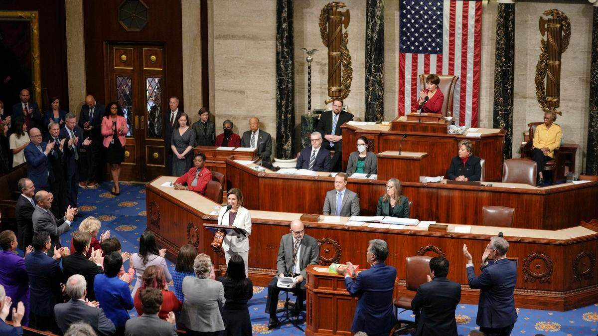 Lawmakers stand and applaud as Speaker Nancy Pelosi announces her decision to step down from Democratic leadership on the House floor Thursday, Nov. 17.