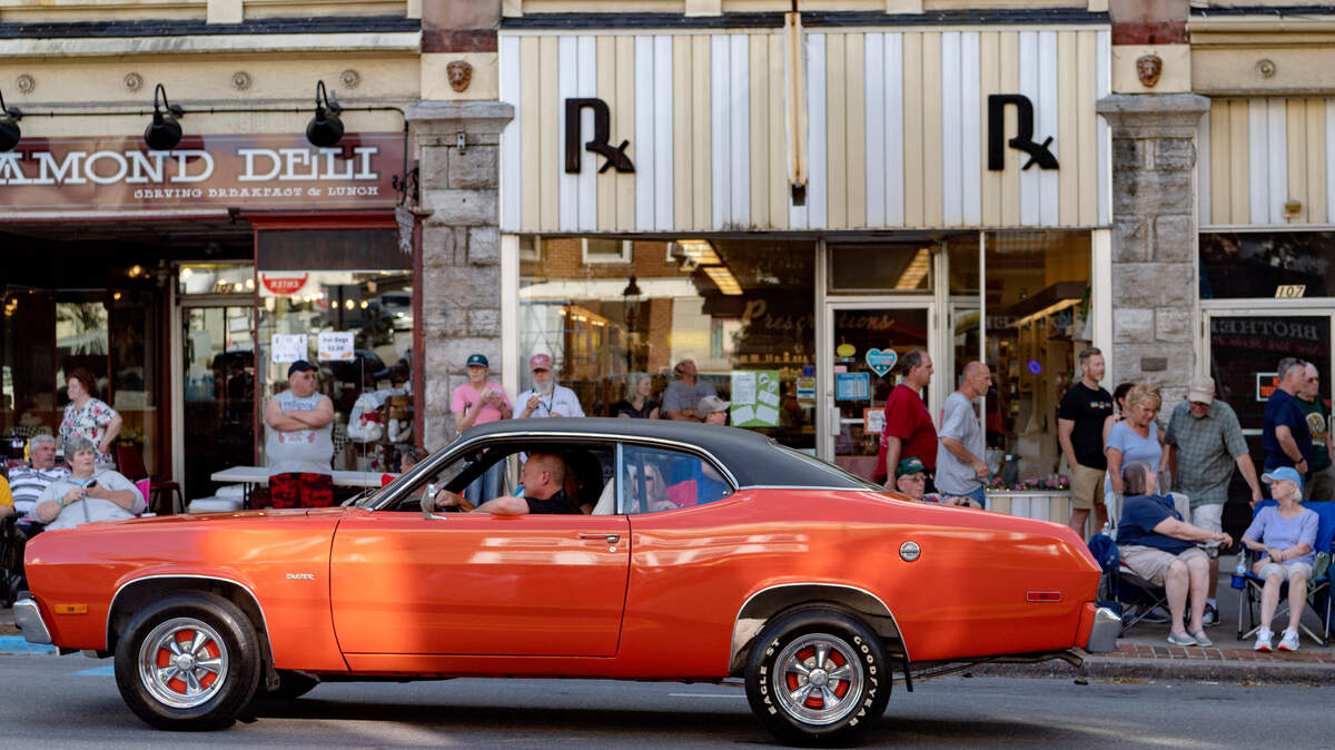 A Plymouth Duster cruises past the crowd on Allegheny Street for the Bellefonte Cruise on Friday, June 17, 2022.