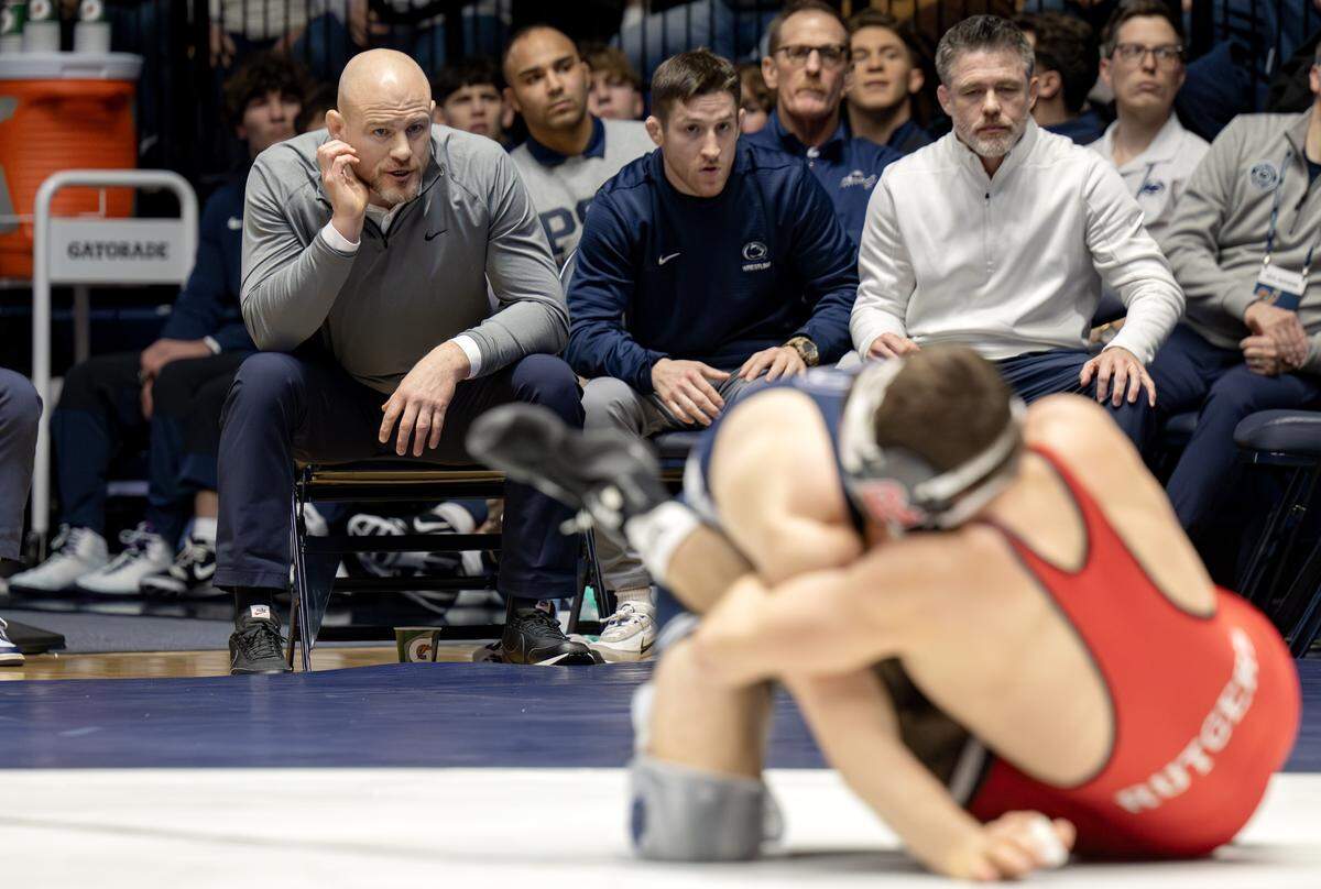 Penn State wrestling coaches (from left) Cael Sanderson, Nick Lee and Cody Sanderson yell to Marcus Blaze during his 133 lb bout against Rutgers’ Dylan Shawver on Saturday, Jan. 10, 2026 in Rec Hall.  