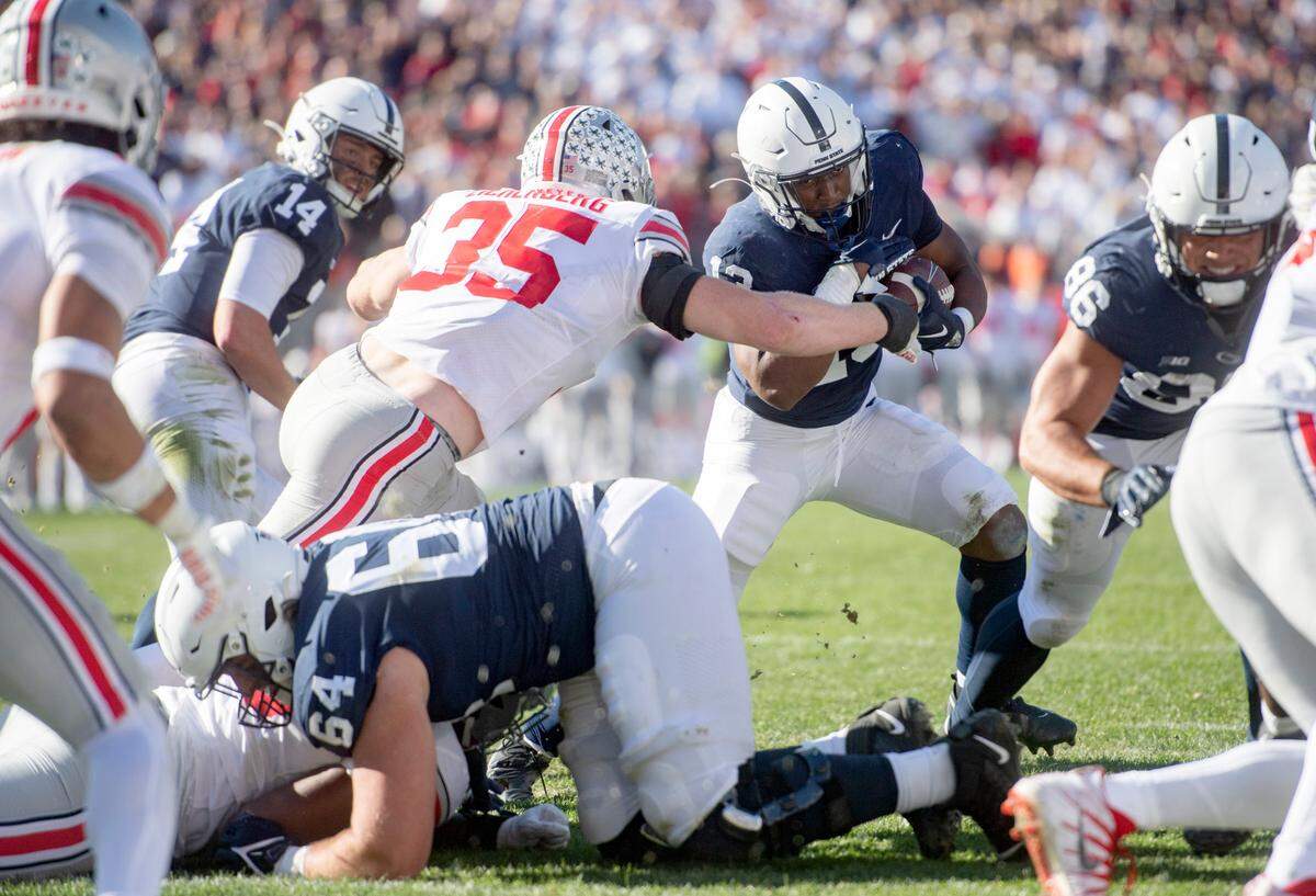 Penn State running back Kaytron Allen cuts around Ohio State defenders and into the endzone for a touchdown during the game on Saturday, Oct. 29, 2022.