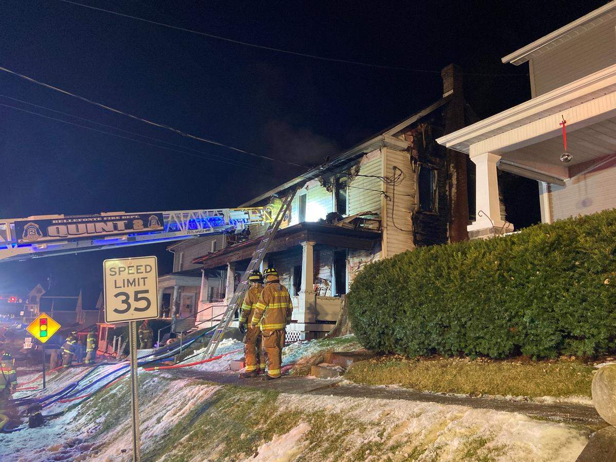 Firefighters work at the scene of a two-building fire on West Water Street in Spring Township on Dec. 30.