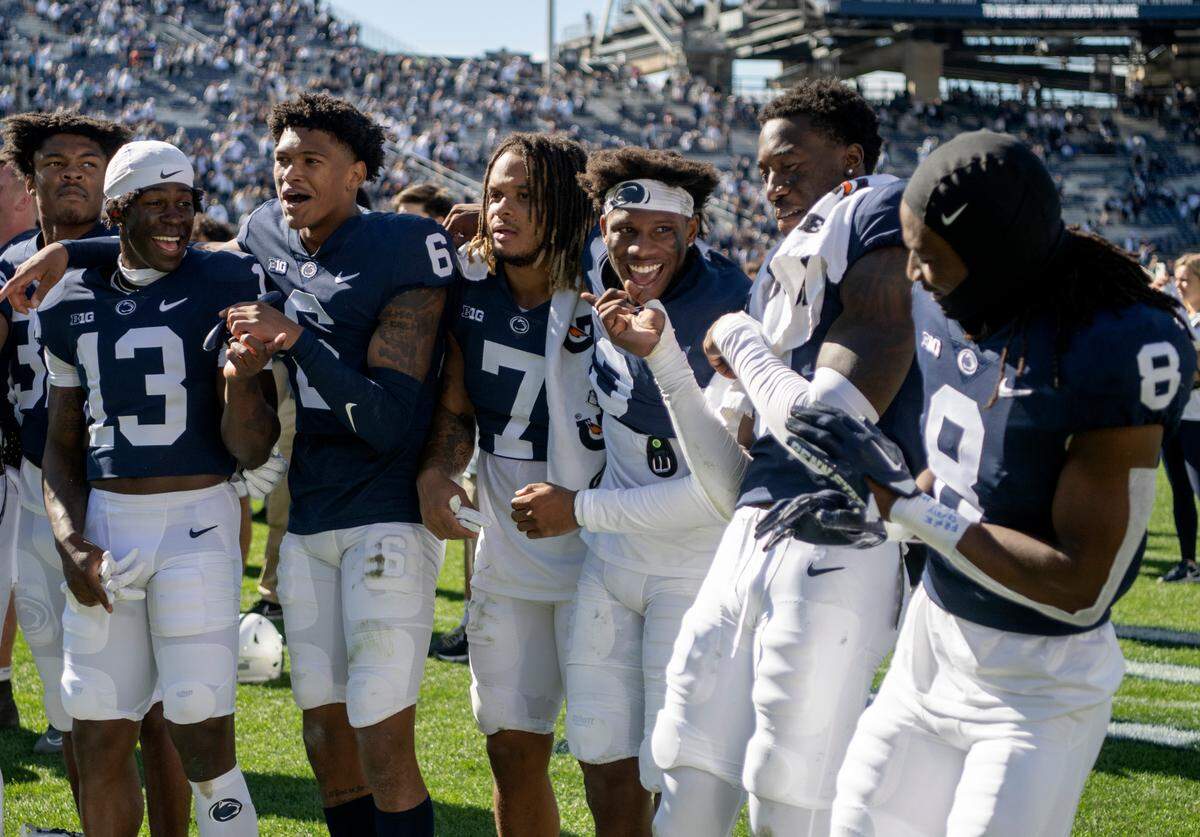 Penn State football players laugh together as they sing and dance to the Penn State alma mater after the win over Central Michigan on Saturday, Sept. 24, 2022.