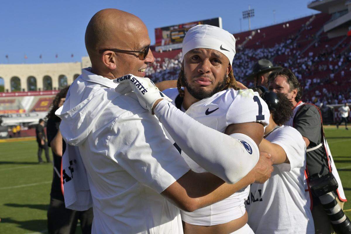 Oct 12, 2024; Los Angeles, California, USA; Penn State Nittany Lions safety Jaylen Reed (1) is congratulated by head coach James Franklin after defeating the USC Trojans in overtime at United Airlines Field at the Los Angeles Memorial Coliseum. Mandatory Credit: Jayne Kamin-Oncea-Imagn Images