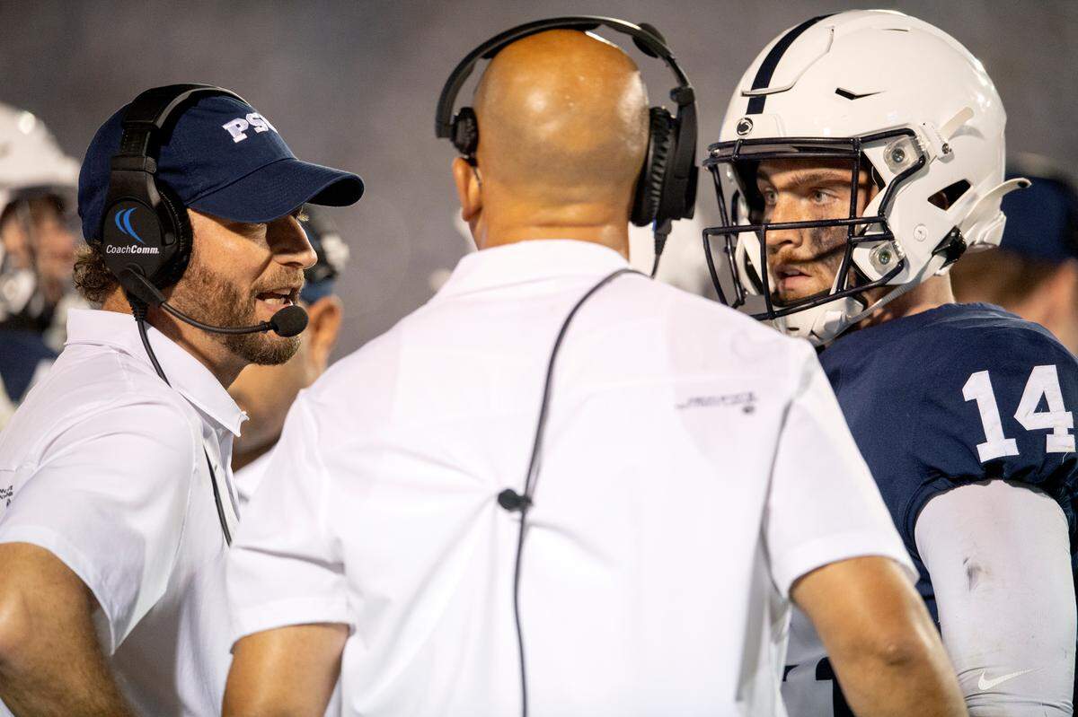Penn State offensive coordinator Mike Yurcich talks with head coach James Franklin and quarterback Sean Clifford during the game against Auburn on Saturday, Sept. 18, 2021.
