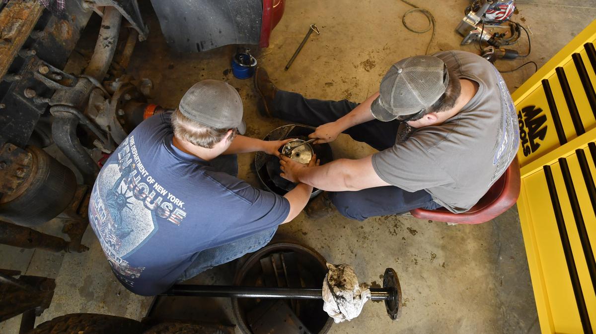Students work together to install a seal on a wheel hub in the diesel tech program at CPI.