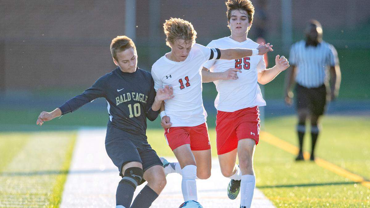 Bald Eagle Area's Noah Giedroc kicks the ball away from Bellefonte's Hayden Walker during the game on Wednesday, Sept. 29, 2021.  