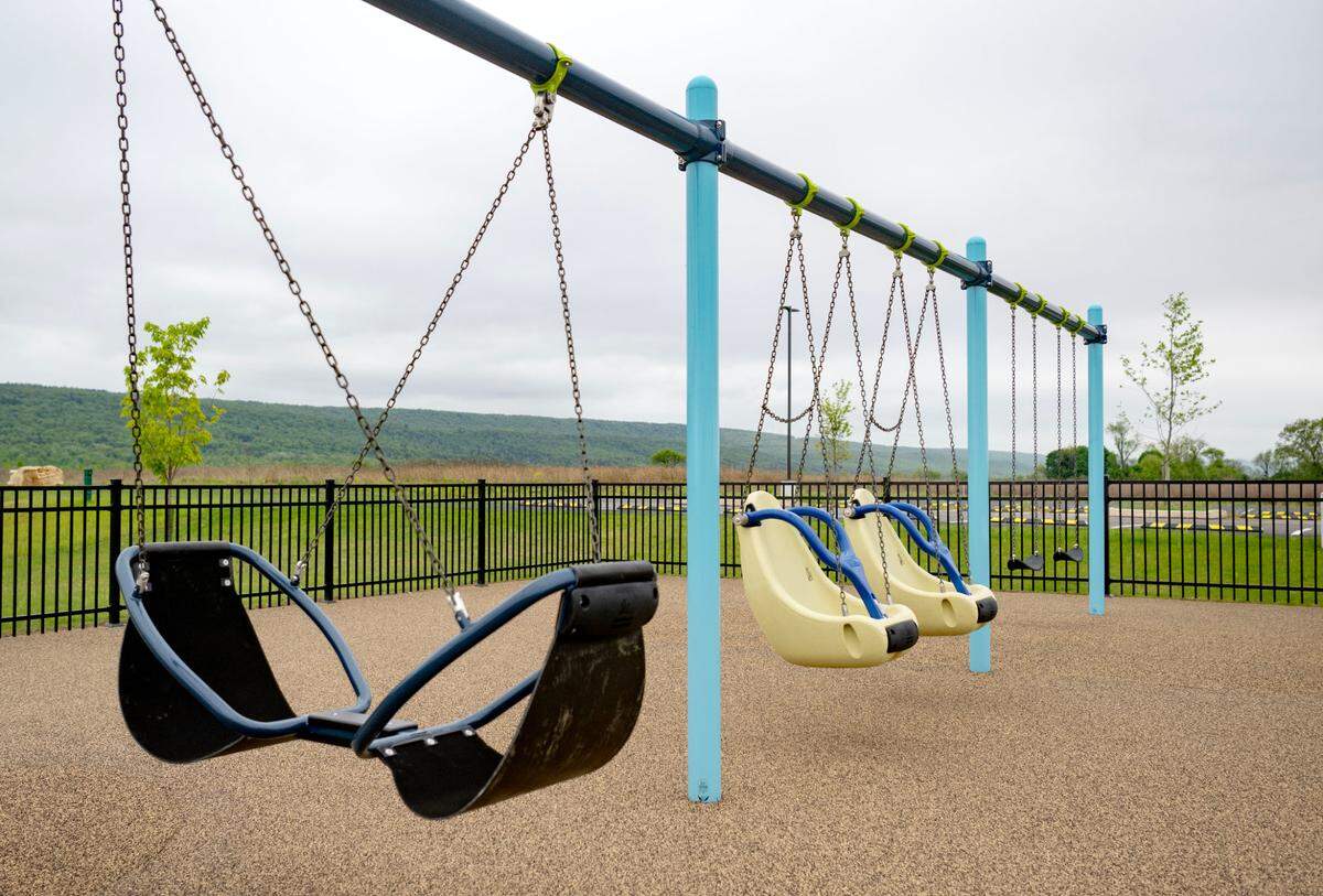 Swings at the all-abilities playground at Whitehall Road Regional Park on Tuesday, May 7, 2024.