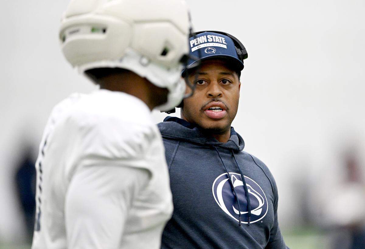 Penn State wide receivers coach Marques Hagans talks to Kyron Hudson during practice on Wednesday, Oct. 29, 2025.