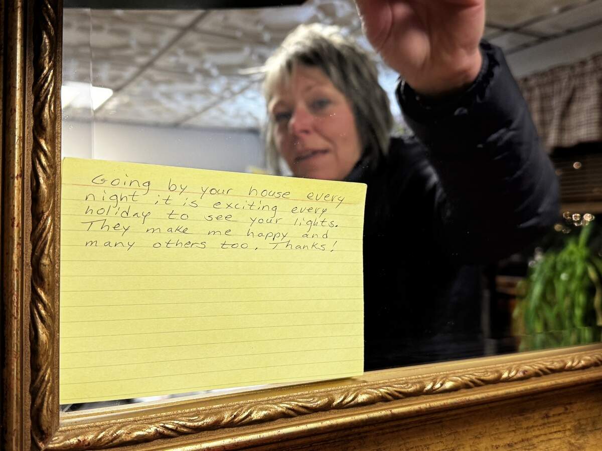 Angel Woodward reads a note left on her property at 545 Flat Rock Road, Port Matilda, on Dec. 3, 2025.
