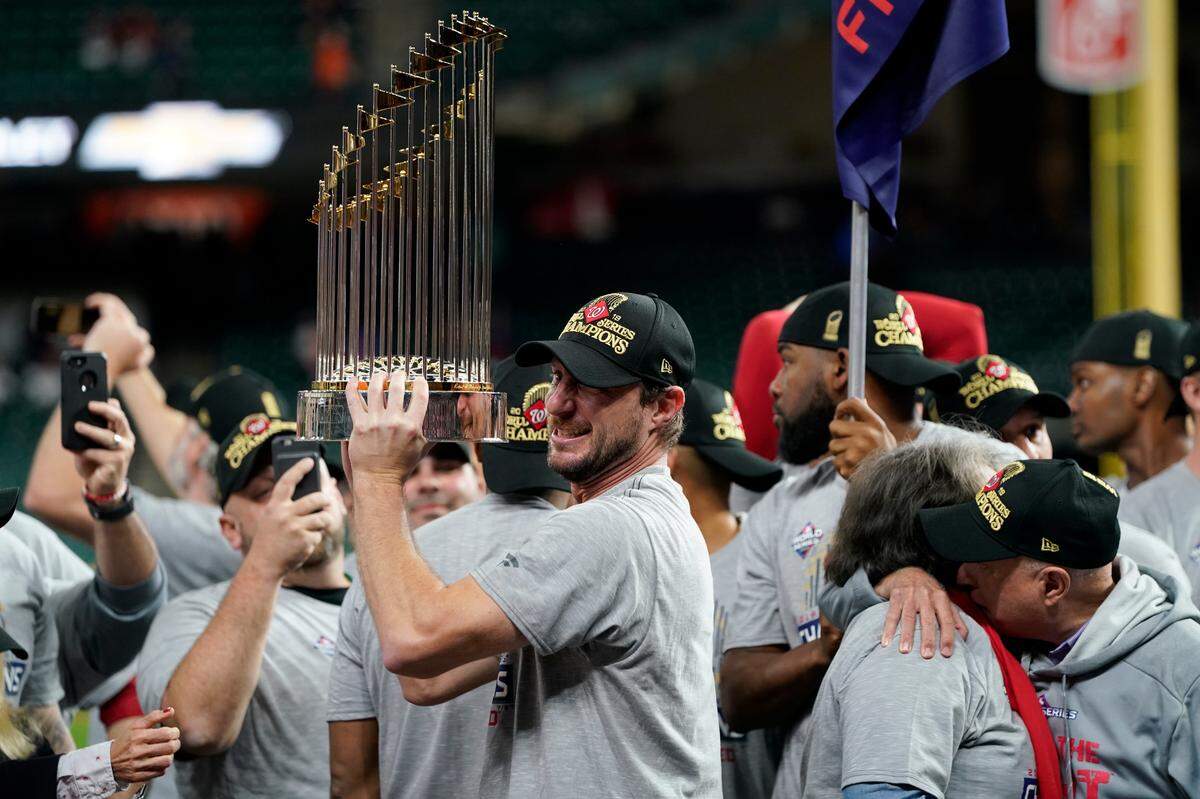 Washington Nationals starting pitcher Max Scherzer celebrates with the trophy after Game 7 of the baseball World Series against the Houston Astros Wednesday, Oct. 30, 2019, in Houston. The Nationals won 6-2 to win the series.