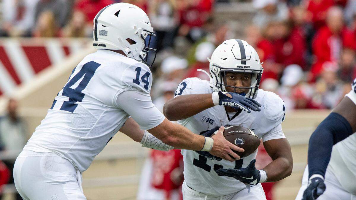Penn State quarterback Sean Clifford (14) hands off the ball to running back Kaytron Allen (13) in the backfield during the first half of an NCAA college football game against Indiana, Saturday, Nov. 5, 2022, in Bloomington, Ind.
