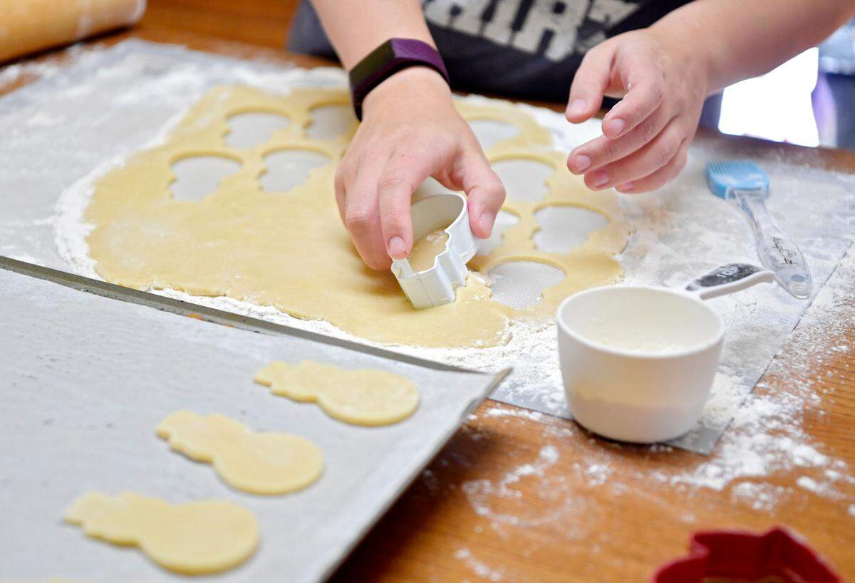 Christina Hallett of Crumbkowski works on sugar cookies for holiday orders on Monday.
