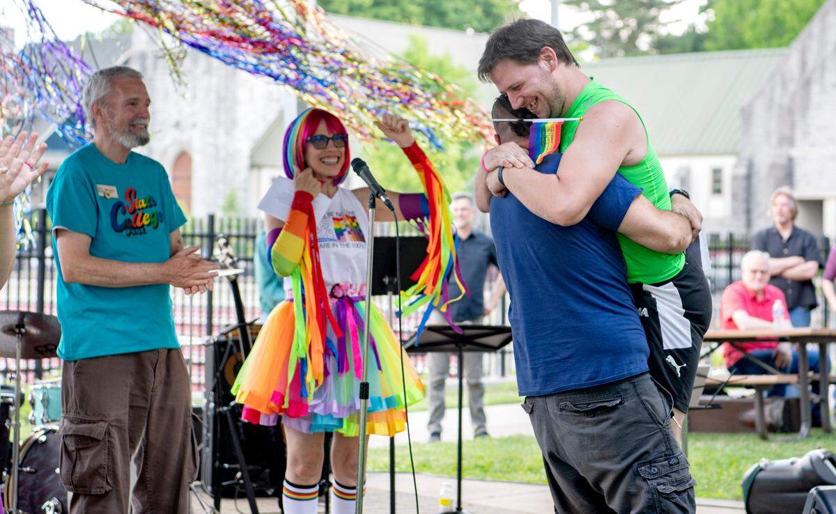 A couple hugs and kisses after being married at the State College Pride celebration on Saturday, June 11, 2022.  