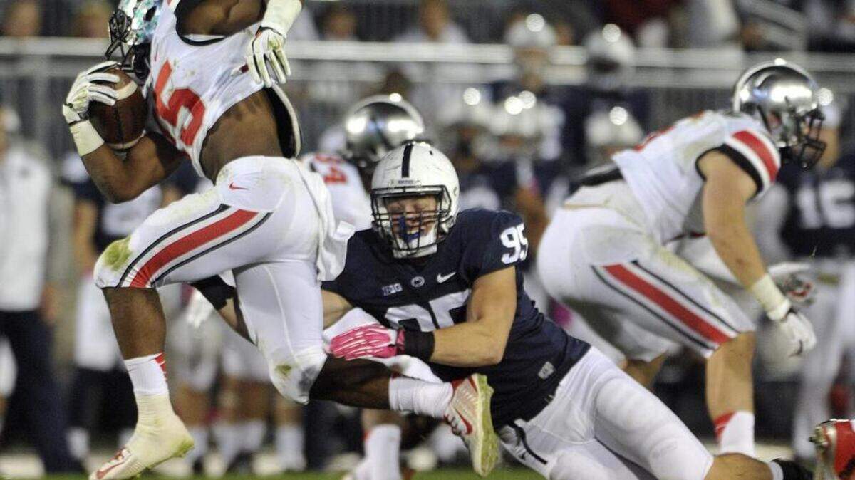 Penn State’s Carl Nassib drags down Ohio State’s Ezekiel Elliott in 2014. Nassib continued with the tenacity that earned him a walk-on spot for the Nittany Lions and elevated his game to the starting defensive end spot. 
