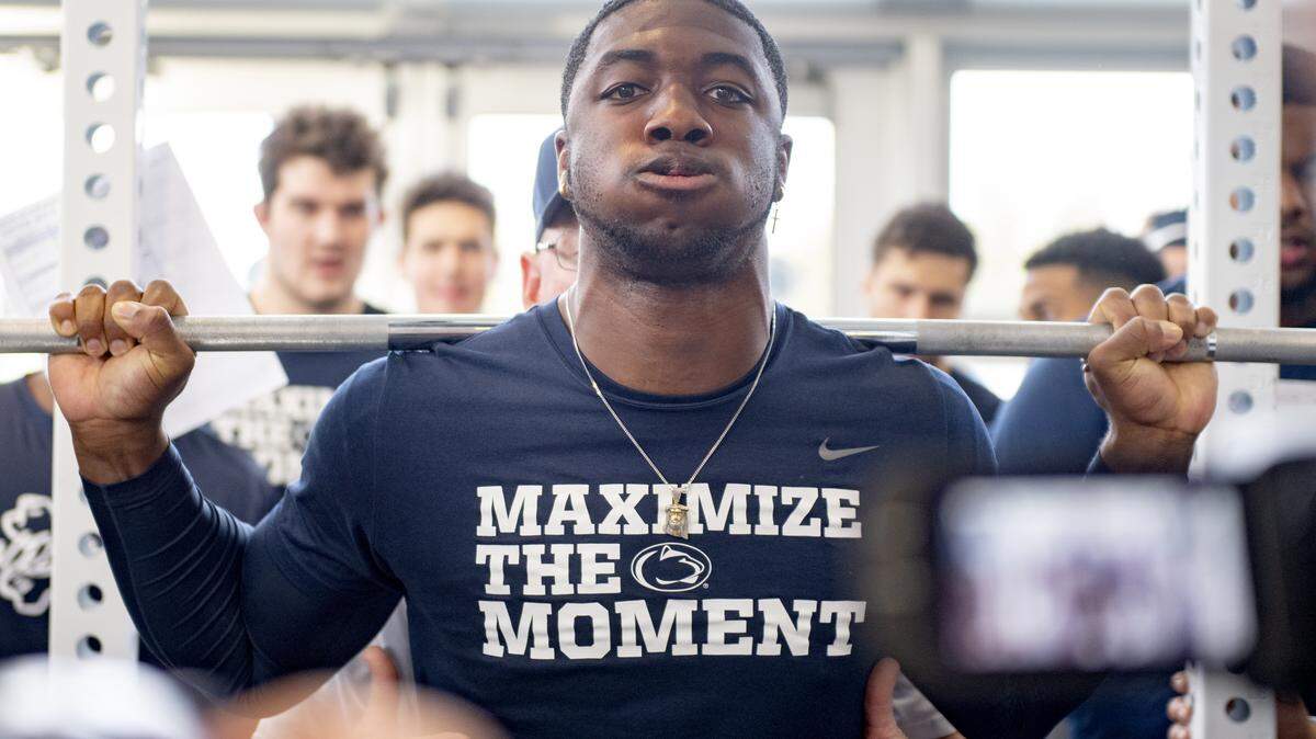 Penn State defensive end Jayson Oweh squats as teammates cheer him on during a strength training session on Thursday, Feb 28, 2019.
