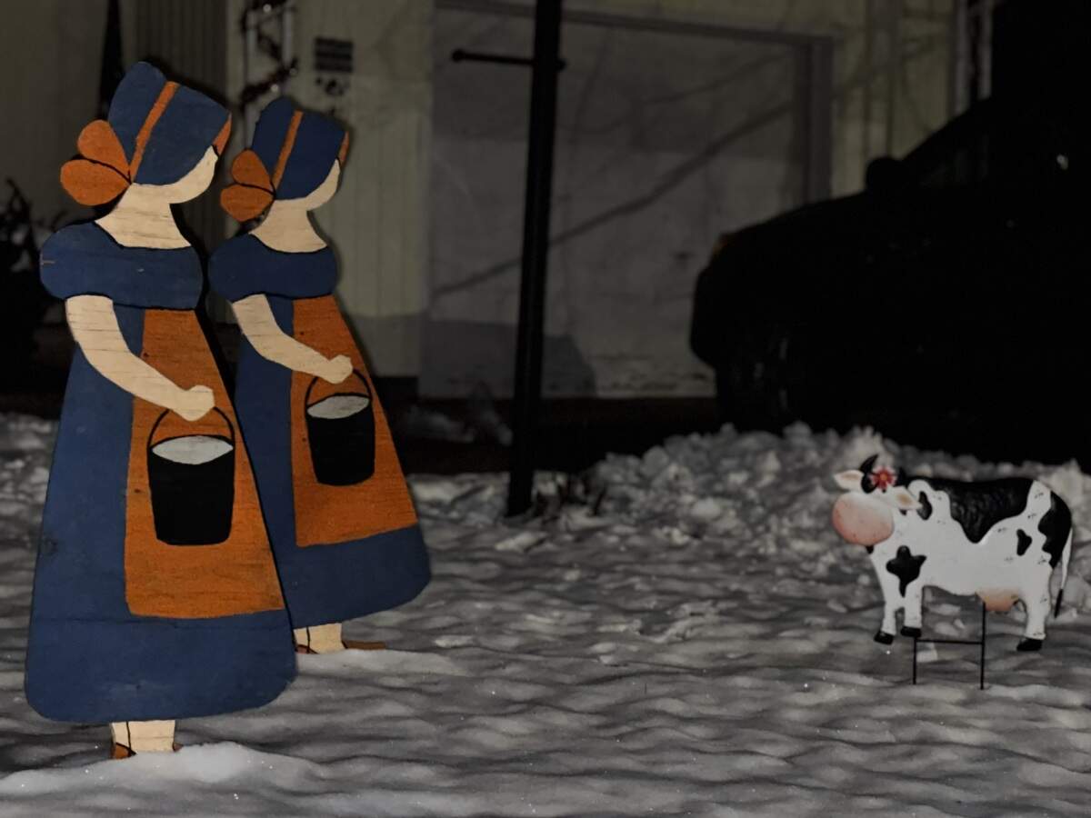 Two of the eight maids a-milking — and a cow — at 906 S. Sparks St., State College, on Dec. 4, 2025