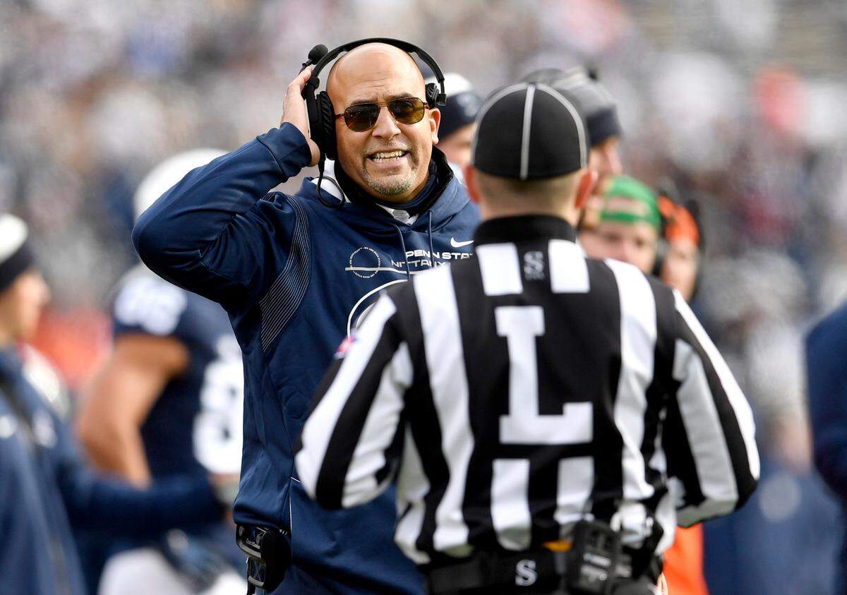 Penn State football coach James Franklin talks to a coach during the game against Rutgers on Saturday, Nov. 20, 2021.