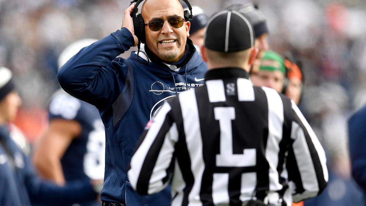 Penn State football coach James Franklin talks to a coach during the game against Rutgers on Saturday, Nov. 20, 2021.