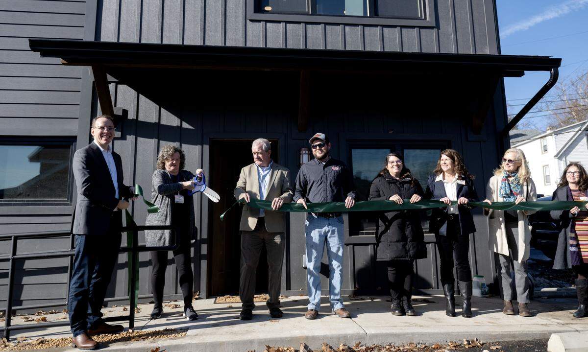 Colleen Ritter of the State College Land Trust cuts the ribbon for the new Old Boalsburg Road Flats on Wednesday, Dec. 17, 2025. The building has two, one-bedroom apartments. 