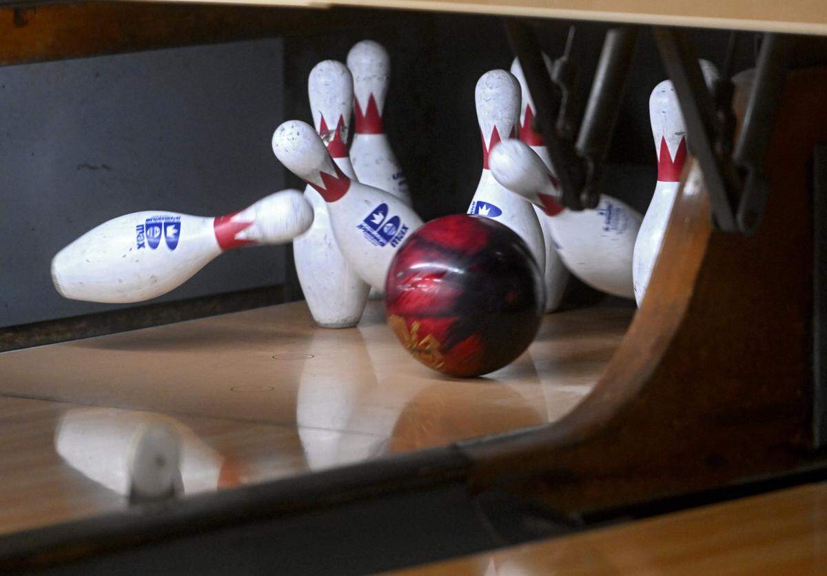 Pins fly for a bowler’s strike at Bellefonte Lanes on Wednesday, April 5, 2023.